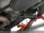 Removing the swaybar...drop the passenger side first and work the other end around the top of the exhaust. TIP: Removing the dri