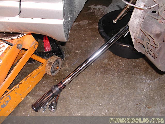 breaker bar (or torque wrench in this case) used to loosen the 2-18mm bolts securing the stock caliper (instructions said 17mm).