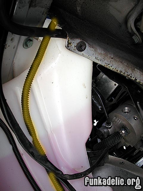 routing behind the the windshield washer reservoir